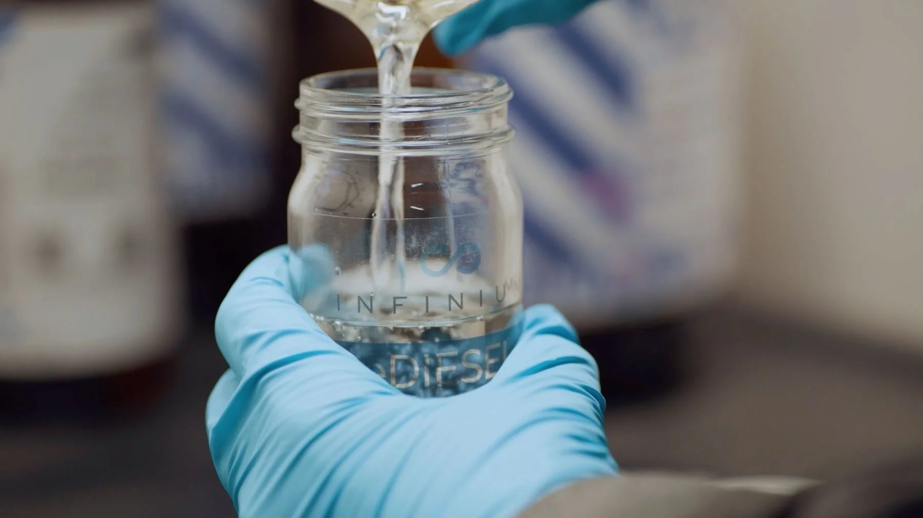 Infinium eDiesel, clear and bright, being poured into a branded sample jar